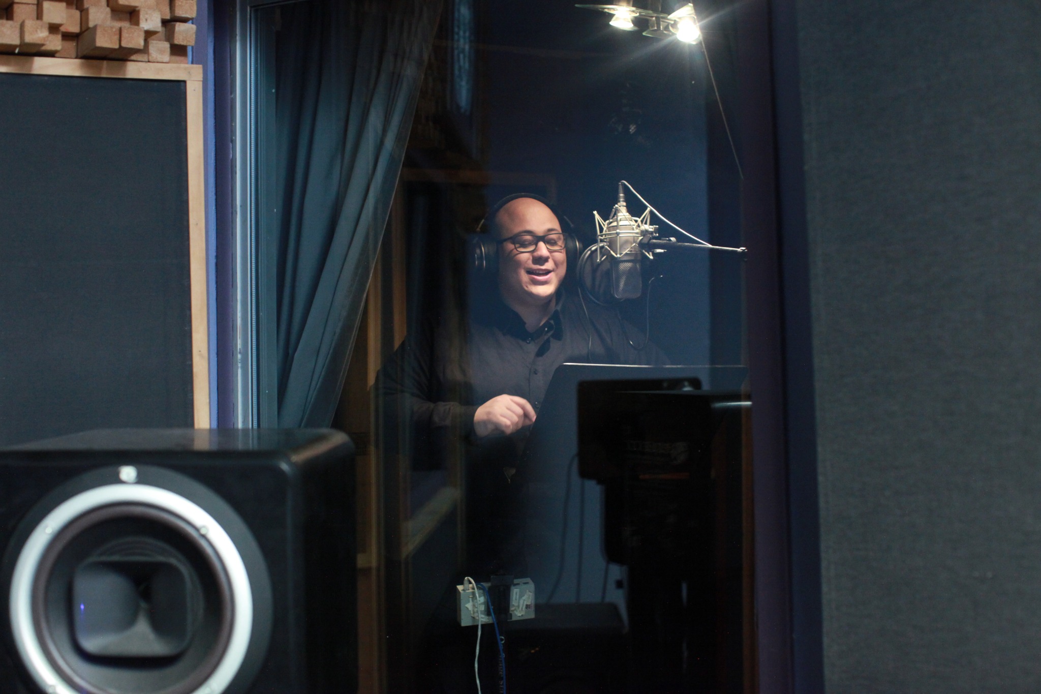 Andrew Reyes recording voiceover in studio